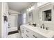 Well-lit bathroom featuring a double sink vanity, decorative mirrors, and a shower-tub combination at 1099 Sheer Paradise Ln # 1, Henderson, NV 89002