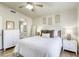 Inviting bedroom with a plush bed, coordinated nightstands, and archway leading to en suite bathroom at 1099 Sheer Paradise Ln # 1, Henderson, NV 89002