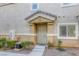 Inviting townhome with a sheltered front entry, manicured landscape, and a large window at 1099 Sheer Paradise Ln # 1, Henderson, NV 89002