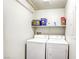 Bright laundry room with a washer, dryer, and shelf for storage at 1099 Sheer Paradise Ln # 1, Henderson, NV 89002