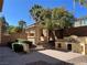 Beautiful backyard featuring a gazebo, built-in grill, brick pavers, palm trees, and lush landscaping at 11009 Royal Highlands St, Las Vegas, NV 89141