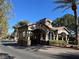 Community gatehouse featuring stone accents, decorative architecture, and well-kept landscaping at 11009 Royal Highlands St, Las Vegas, NV 89141