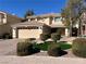 Attractive two-story home featuring a two-car garage and manicured front lawn with decorative landscaping at 11009 Royal Highlands St, Las Vegas, NV 89141