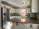 Bright kitchen featuring stainless steel appliances, granite countertops, and white cabinetry at 11009 Royal Highlands St, Las Vegas, NV 89141