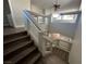 Modern staircase with wood steps, glass panels, and contemporary lighting fixture at 11009 Royal Highlands St, Las Vegas, NV 89141