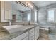 Elegant bathroom featuring dual vanities, a spacious mirror, and a luxurious walk-in shower for a spa-like experience at 11396 Ogden Mills Dr # 101, Las Vegas, NV 89135
