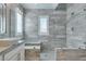 Contemporary bathroom with a large walk-in shower, modern fixtures, and a soothing color palette for a tranquil retreat at 11396 Ogden Mills Dr # 101, Las Vegas, NV 89135