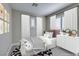 Charming bedroom features a comfortable bed, stylish decor, and plenty of natural light from the window at 11396 Ogden Mills Dr # 101, Las Vegas, NV 89135