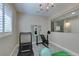 Bright workout room with a treadmill, weight bench, mirrored wall, and modern tile flooring at 11396 Ogden Mills Dr # 101, Las Vegas, NV 89135