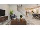 Open concept living room showcases hardwood floors, stairs, and eat-in kitchen at 11396 Ogden Mills Dr # 101, Las Vegas, NV 89135