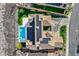 Stunning aerial view showcasing a modern home with a private pool, solar panels, and meticulously landscaped yard at 1320 Enchanted River Dr, Henderson, NV 89012