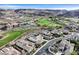 Aerial view of homes nestled within a golf course community against mountain views at 1320 Enchanted River Dr, Henderson, NV 89012