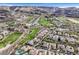 An aerial view of a golf course community surrounded by the natural desert landscape at 1320 Enchanted River Dr, Henderson, NV 89012