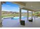 Resort-style backyard featuring a pool, spa, and outdoor seating with mountain views at 1320 Enchanted River Dr, Henderson, NV 89012