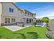 Expansive backyard with manicured synthetic lawn, pool, and patio perfect for outdoor entertaining at 1320 Enchanted River Dr, Henderson, NV 89012