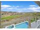 Relaxing views from the balcony featuring a pool, a golf course, and a mountain landscape at 1320 Enchanted River Dr, Henderson, NV 89012