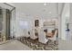 Dining room with elegant table set, modern lighting, and wine storage at 1320 Enchanted River Dr, Henderson, NV 89012