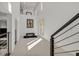 Bright entryway with soaring ceilings, art, and modern staircase with metal railings at 1320 Enchanted River Dr, Henderson, NV 89012