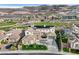 Beautiful aerial view of a landscaped home, solar panels, and golf course view at 1320 Enchanted River Dr, Henderson, NV 89012