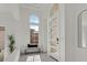 Elegant front entry with a modern door, transom window, and light-filled foyer at 1320 Enchanted River Dr, Henderson, NV 89012