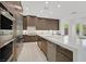 Modern kitchen featuring stainless appliances, an island with bar seating, and sleek countertops at 1320 Enchanted River Dr, Henderson, NV 89012