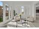Bright and airy living room featuring modern furniture, white walls, and abundant natural light at 1320 Enchanted River Dr, Henderson, NV 89012