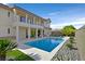 A luxurious pool is nestled between the house and manicured landscaping, providing a private outdoor oasis at 1320 Enchanted River Dr, Henderson, NV 89012