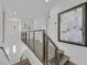 Elegant staircase with wood steps, and modern railings leads to the bright upper floor at 1320 Enchanted River Dr, Henderson, NV 89012