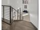 Modern staircase with wooden steps and horizontal iron railings leads to the upper level at 1320 Enchanted River Dr, Henderson, NV 89012