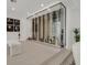 Beautiful wine storage with glass enclosure, bench, and recessed lighting at 1320 Enchanted River Dr, Henderson, NV 89012