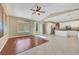 Open-concept living space featuring light tile flooring, a ceiling fan, and a view into the kitchen at 1372 Coppelia Ct, Henderson, NV 89052