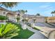 Stunning home featuring manicured landscaping, driveway, and attached garages under a blue sky at 177 Knollwood Ct, Henderson, NV 89074