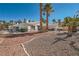 Landscaped backyard featuring a patio and desert landscaping with palms, a pool, and an outdoor dining area at 1831 Rosemere Ct, Las Vegas, NV 89117