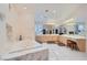 Luxurious bathroom boasts a marble-surround soaking tub, marble counters and ample vanity storage at 1831 Rosemere Ct, Las Vegas, NV 89117
