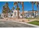 Charming home exterior with desert landscaping, palm trees, and a paved driveway leading to a three-car garage at 1831 Rosemere Ct, Las Vegas, NV 89117