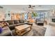 Open-concept living area with a stone fireplace, comfortable seating, and an adjacent kitchen and dining space at 1831 Rosemere Ct, Las Vegas, NV 89117