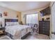 This well-lit bedroom features modern decor, wood-look floors, and a large window at 1933 Orchard Valley Dr, Las Vegas, NV 89142