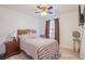 Cozy bedroom with light wood-look floors, ceiling fan, and neutral decor at 1933 Orchard Valley Dr, Las Vegas, NV 89142