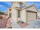 Close up of home's front door and two-car garage at 1933 Orchard Valley Dr, Las Vegas, NV 89142