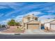 Two-story home features desert landscaping and a two-car garage at 1933 Orchard Valley Dr, Las Vegas, NV 89142