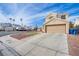Two-story home with desert landscaping, lawn, and a two-car garage at 1933 Orchard Valley Dr, Las Vegas, NV 89142
