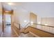 Bright hallway with wood floors, railing, and stairs to another level at 1933 Orchard Valley Dr, Las Vegas, NV 89142