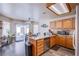 Well-lit kitchen featuring granite counters, wood cabinets, stainless appliances, and sliding doors to backyard at 1933 Orchard Valley Dr, Las Vegas, NV 89142