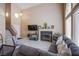 Comfortable living room with a stone fireplace, large windows with plenty of light, and cozy furniture at 1933 Orchard Valley Dr, Las Vegas, NV 89142