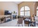 Open concept living area with a fireplace, large windows, and cozy seating at 1933 Orchard Valley Dr, Las Vegas, NV 89142