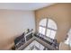 Bright living room featuring a fireplace, a comfortable couch, and a large arched window with natural light at 1933 Orchard Valley Dr, Las Vegas, NV 89142