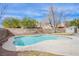 Backyard view of a private pool surrounded by landscaping and a brick privacy fence at 1933 Orchard Valley Dr, Las Vegas, NV 89142