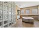 Luxurious bathroom featuring glass block wall and a large, unique soaking tub at 2858 Red Arrow Dr, Las Vegas, NV 89135