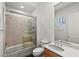 Bathroom with shower and bath with glass door, decorative tile and a large vanity mirror at 2858 Red Arrow Dr, Las Vegas, NV 89135