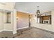 Elegant living room with tile floors, chandelier, fireplace, and an open floor plan is perfect for entertaining at 2858 Red Arrow Dr, Las Vegas, NV 89135